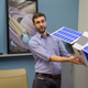 Planetary geologist Craig Hardgrove with a model of the satellite. (Arizona State University)